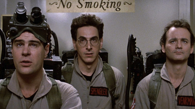Peter Venkman (Bill Murray), Egon Spengler (Harold Ramis), and Ray Stantz (Dan Aykroyd) stand in their Ghostbusters gear in Ghostbusters