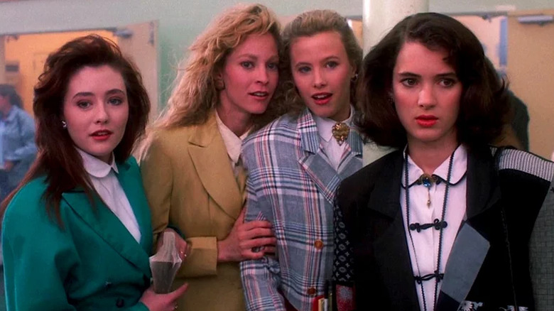 The Heathers, played by Shannen Doherty, Lisanne Falk, and Kim Walker, with semi-reluctant protegee Veronica, played by Winona Ryder