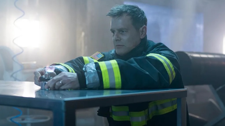 Peter Krause kneels in prayer as Bobby Nash in 9-1-1