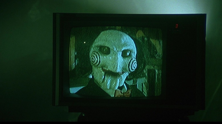Jigsaw doll on TV in Saw