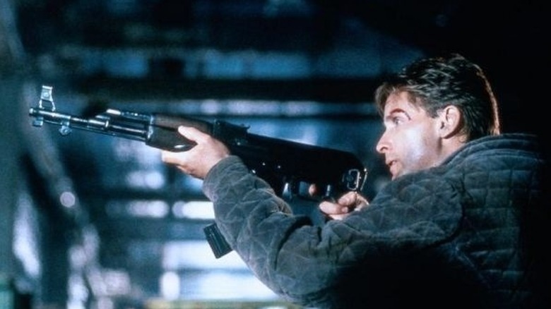 Alex pointing gun at Vacendak