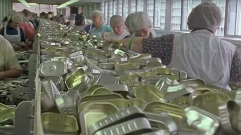 factory workers sorting tins