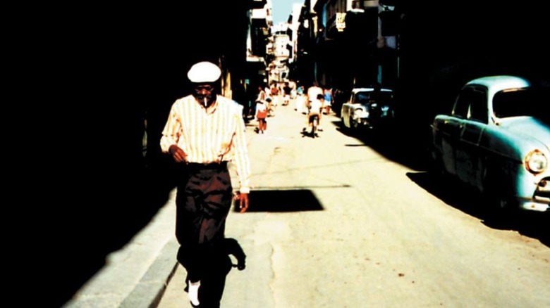 man smoking walking in cuba