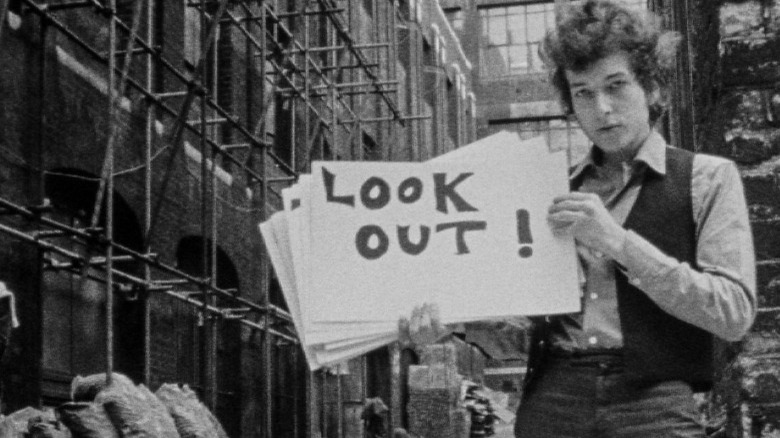 bob dylan holding sign