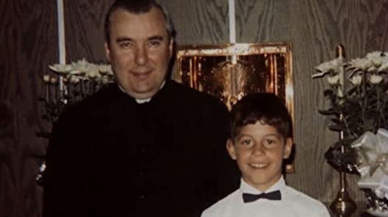 priest and child together