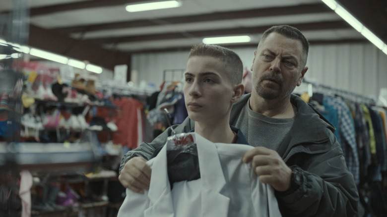 Nick Offerman's Jerry Kane holds up a shirt on Jacob Tremblay's Joe Kane in Sovereign