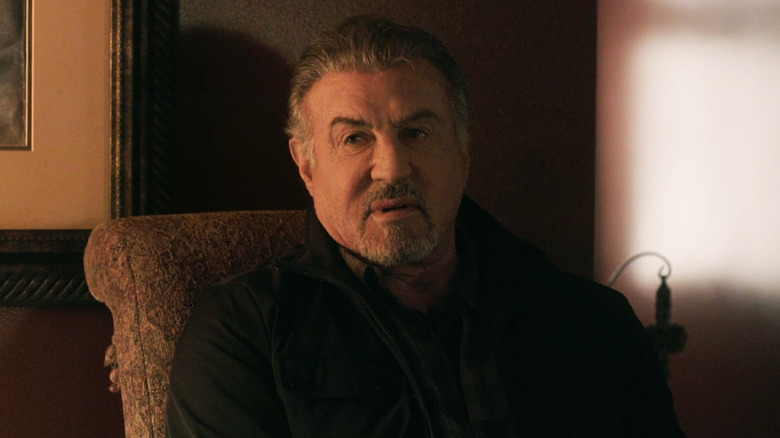 Sylvester Stallone as Chester client sits on a chair in AlaRome