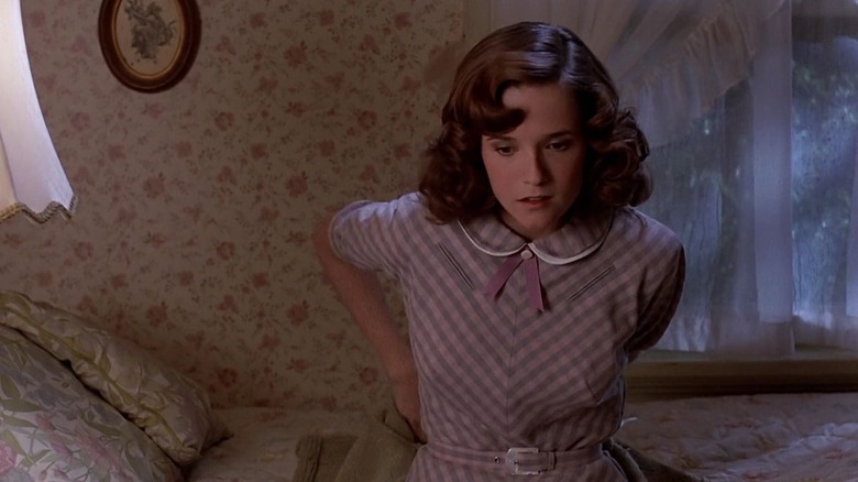 Lea Thompson as Lorraine sitting on her bed in Back to the Future
