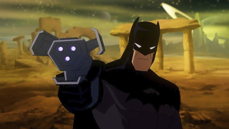 Batman in Justice League: Crisis on Two Earths holding multiverse travel gun