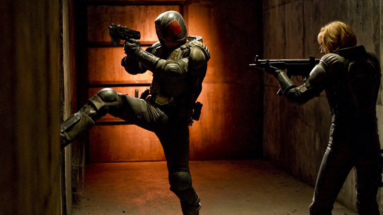 Karl Urban's Judge Dredd and Olivia Thrilby's Anderson kicking in a door in Dredd