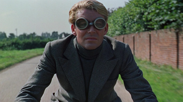 T.E. Lawrence (Peter O'Toole) wearing goggles while riding his motorcycle in Lawrence of Arabia