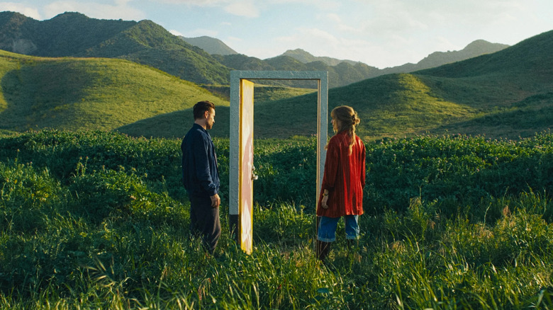 David and Sarah standing next to an open door in a field in A Big Bold Beautiful Journey