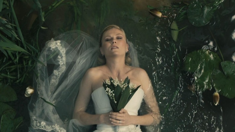 Justine laying in water holding her bouquet in Melancholia