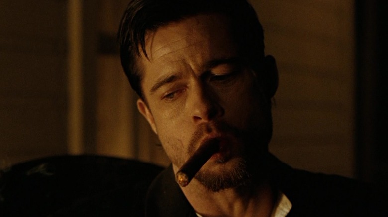 Brad Pitt's Jesse James holds a cigar in his mouth in The Assassination of Jesse James by the Coward Robert Ford