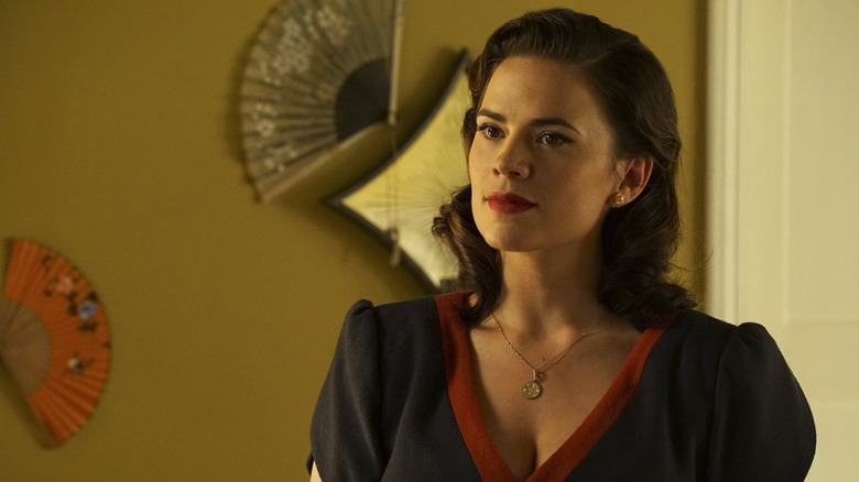 Peggy Carter wearing a blue and red dress in Agent Carter