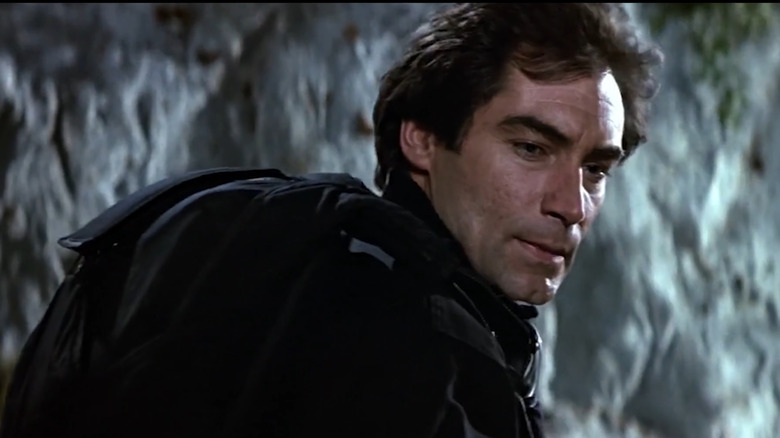 Timothy Dalton as James Bond in a cave in The Living Daylights