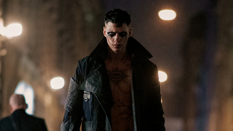 Bill Skarsgaard as Eric, all decked out in tats and face paint, ready to murder people in the remake of The Crow.