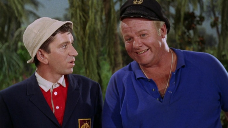 Gilligan is in a sport coat, and the Skipper is saying something to him, smiling. From Gilligan's Island.