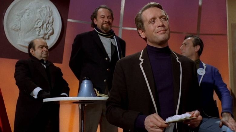 Number Six looking smug in front of a bizarre tribunal in The Prisoner