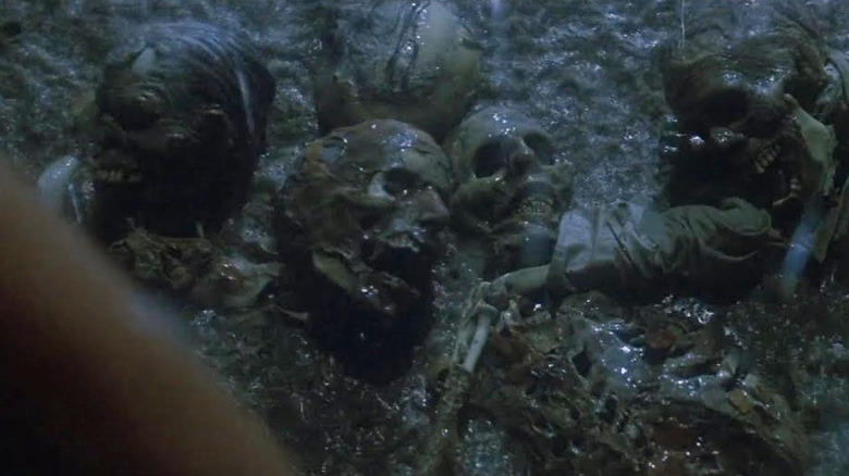 Skeletons bobbing out of a swimming pool in Poltergeist