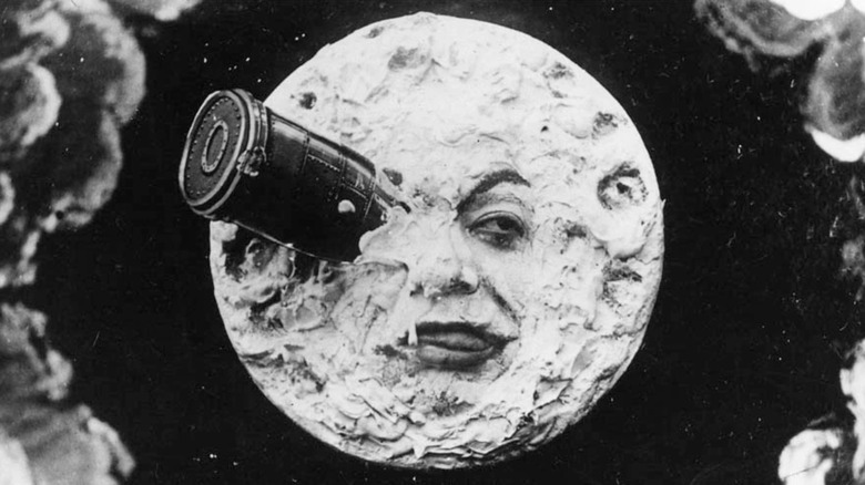 A Trip To The Moon, moon face with rocket lodged in eye
