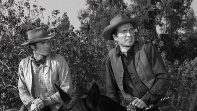 Clint Eastwood as Rowdy Yates sits on a horse alongside Eric Fleming as Gil Favor in Rawhide
