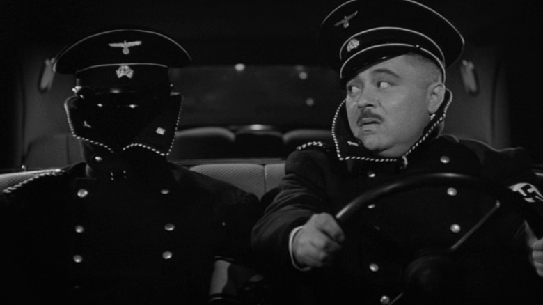 Frank Griffin, invisible, next to a German soldier in a car in Invisible Agent