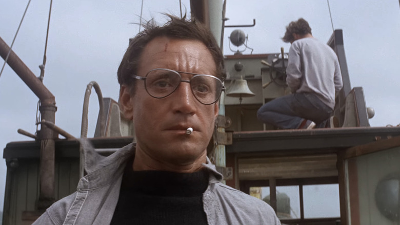 Roy Scheider as Chief Martin Brody looks shocked as he stands on a boat in Jaws