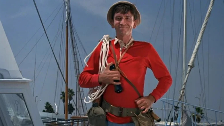 Bob Denver's Gilligan stands in a marina in Gilligan's Island