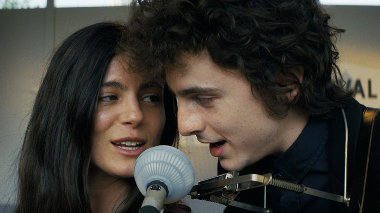Joan Baez and Bob Dylan sing into a microphone in A Complete Unknown