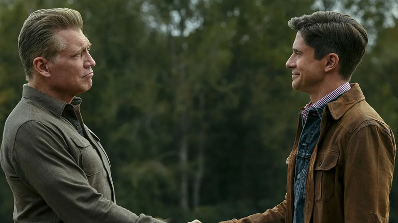 A stone-faced Harlan Buckley shakes hands with the smiling drug lord Grady in The Waterfront