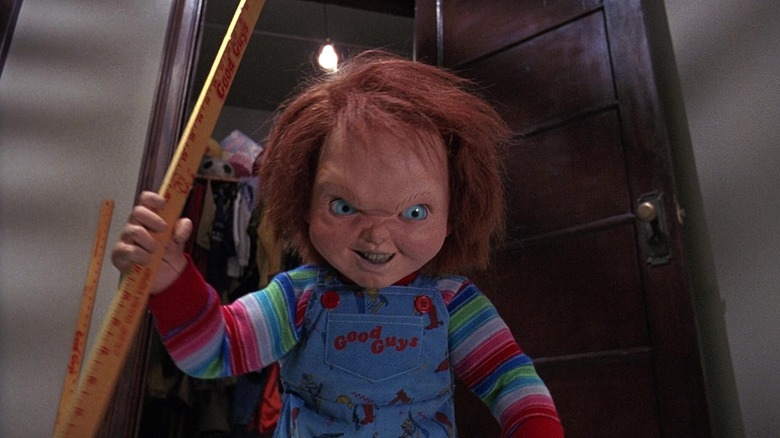 Chucky with a yardstick and a mean expression in Child's Play 2