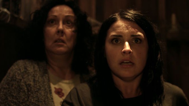 Kylie and Miriam look up in fear in Housebound