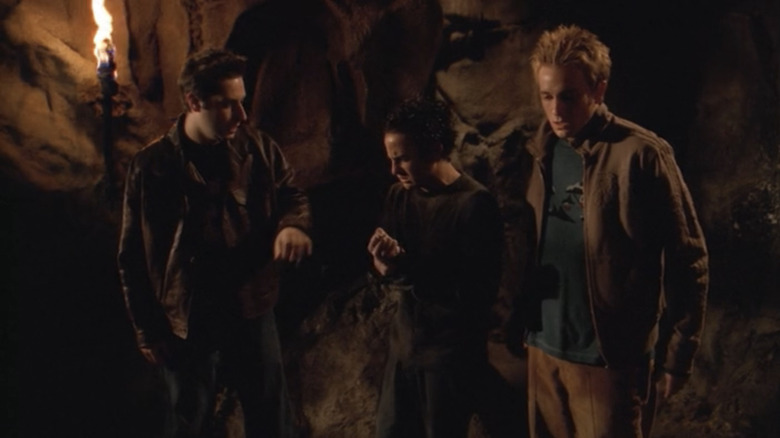 Adam Busch's Warren Mears, Danny Strong's Jonathan Levinson, and Tom Lenk's Andrew Wells stand side by side in a cave in Buffy the Vampire Slayer