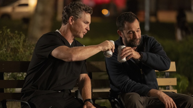 Abbot and Robby drinking beers outside after their shift on The Pitt