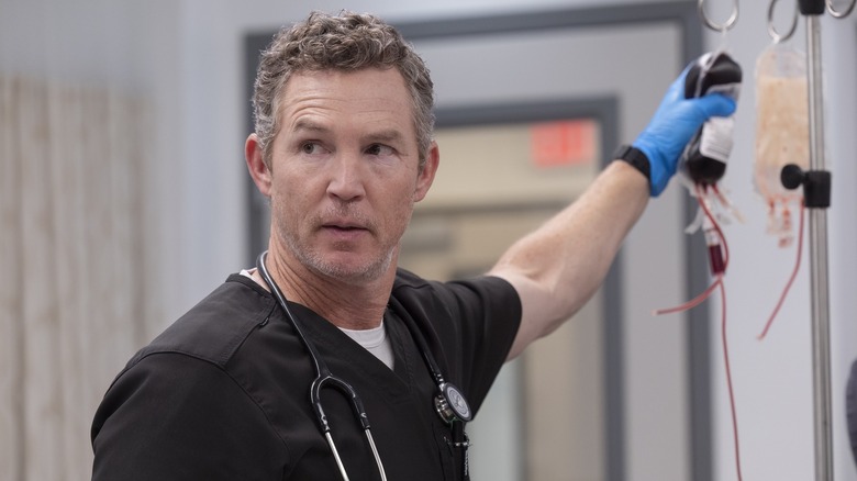 Abbot hanging a blood bag on The Pitt