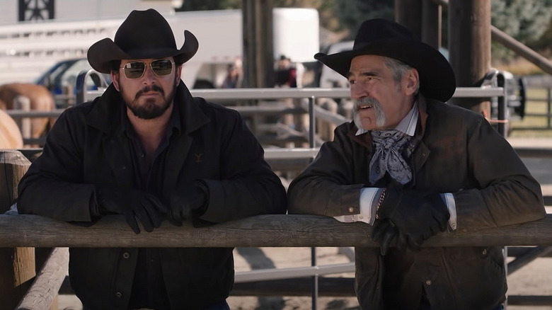 Rip and Lloyd leaning on a fence in Yellowstone