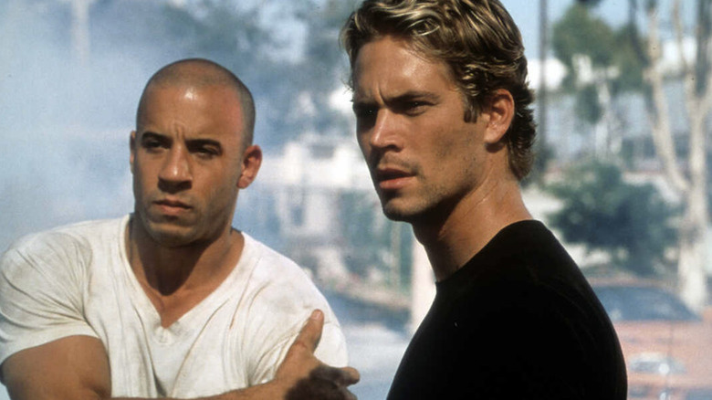 Dominic Toretto (Vin Diesel) and Brian O'Conner (Paul Walker) standing together in The Fast and the Furious