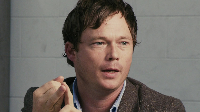 Jason Cope as Grey Bradnam being interviewed for a documentary film in District 9