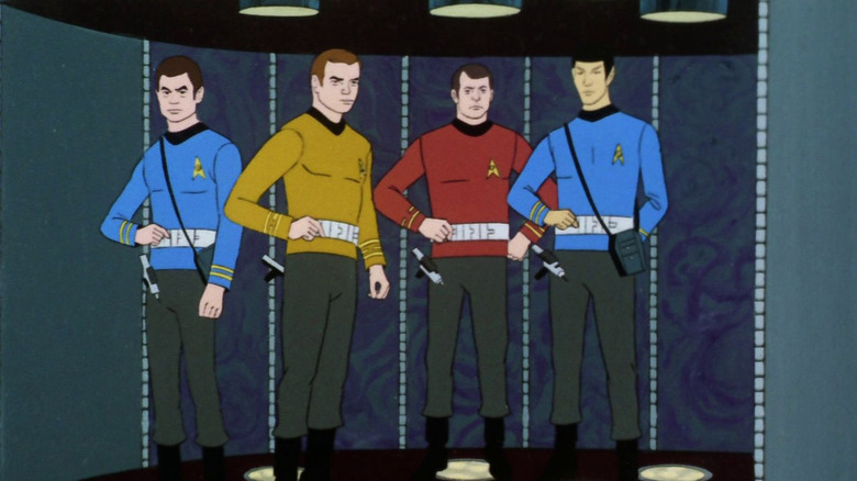Bones, Kirk, Scotty, and Spock on a transporter pad on Star Trek: The Animated Series.