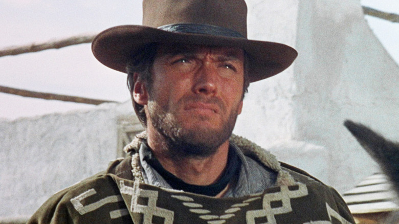 Clint Eastwood's Man with No Name looks off into the distance as he sits on a horse in A Fistful of Dollars