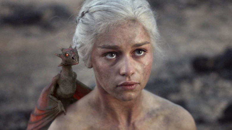 Emilia Clarke as Daenerys with a dragon on her shoulder in Game of Thrones Season 1