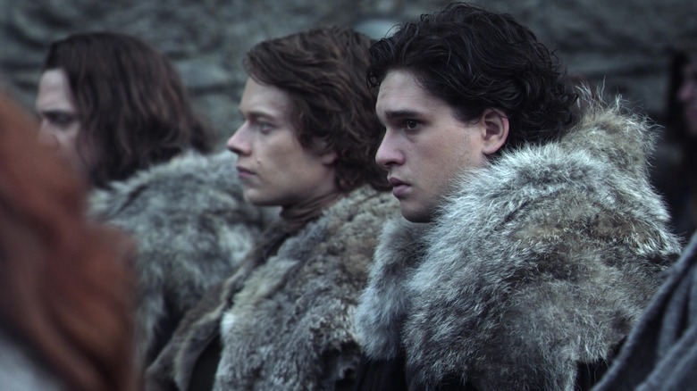 Theon Greyjoy and Jon Snow standing side by side in Game of Thrones