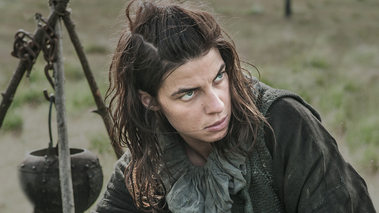 Osha looking to the side wearing black in Game of Thrones