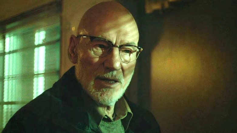 Patrick Stewart as Darcy looking ominous in dim light in Green Room