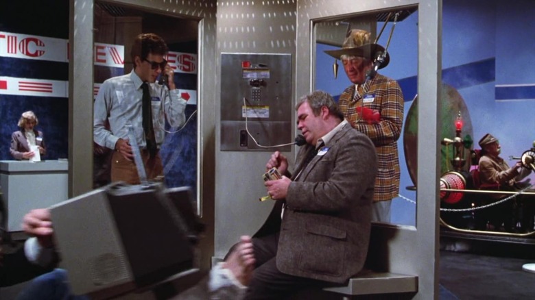 Rand Peltzer on a payphone at a weird convention in Gremlins