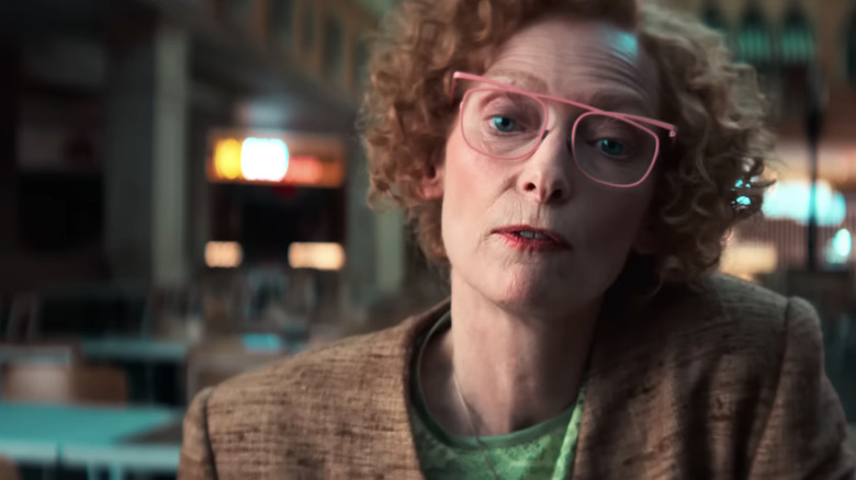 Tilda Swinton as Cynthia Blithe looks across frame in closeup in Ballad of a Small Player