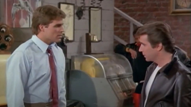 Ted McGinley as Roger Phillips stands opposite Henry Winkler as Fonzie in Happy Days