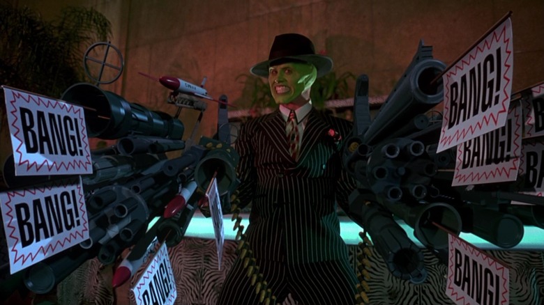Stanley Ipkiss, possessed by the Mask, holding large cartoony guns in The Mask
