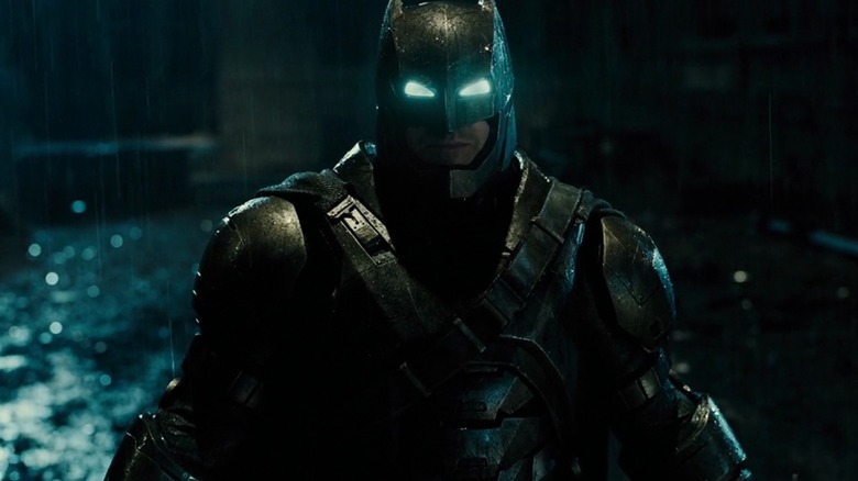 Ben Affleck in the role of Batman in his metal suit stands in the rain in Batman V, Superman: The dawn of justice